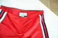 Red conic pants with side pinstripe